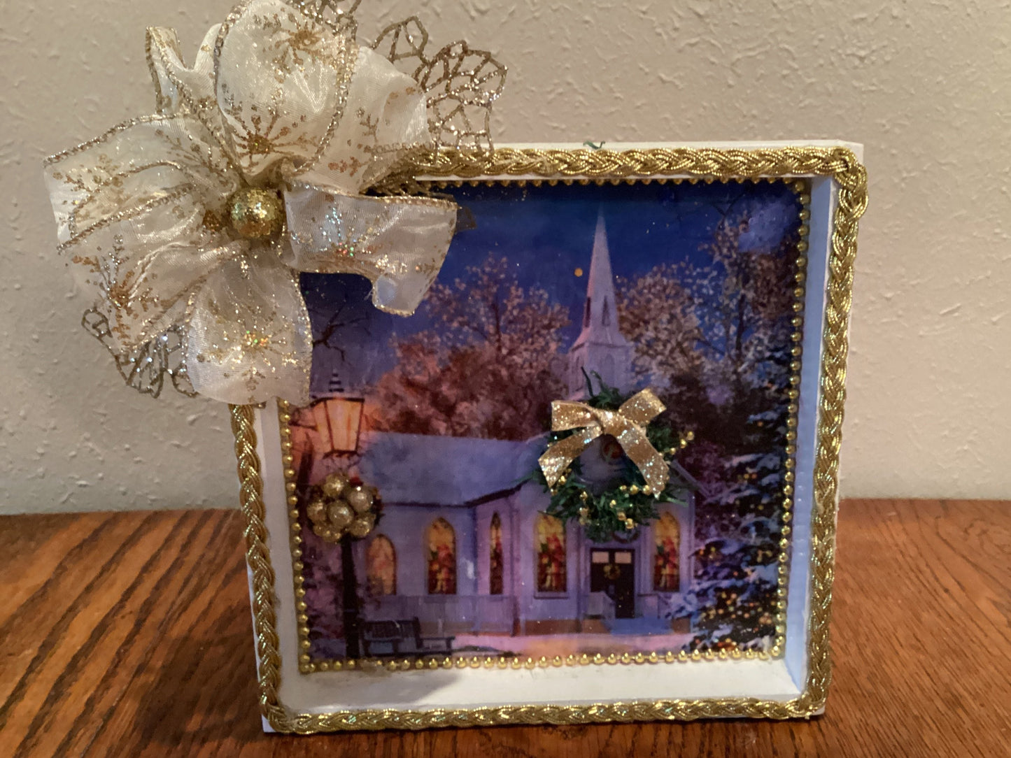 7" X 7" white and gold box with church, Christmas tree, wreath, lamppost, and gold bow