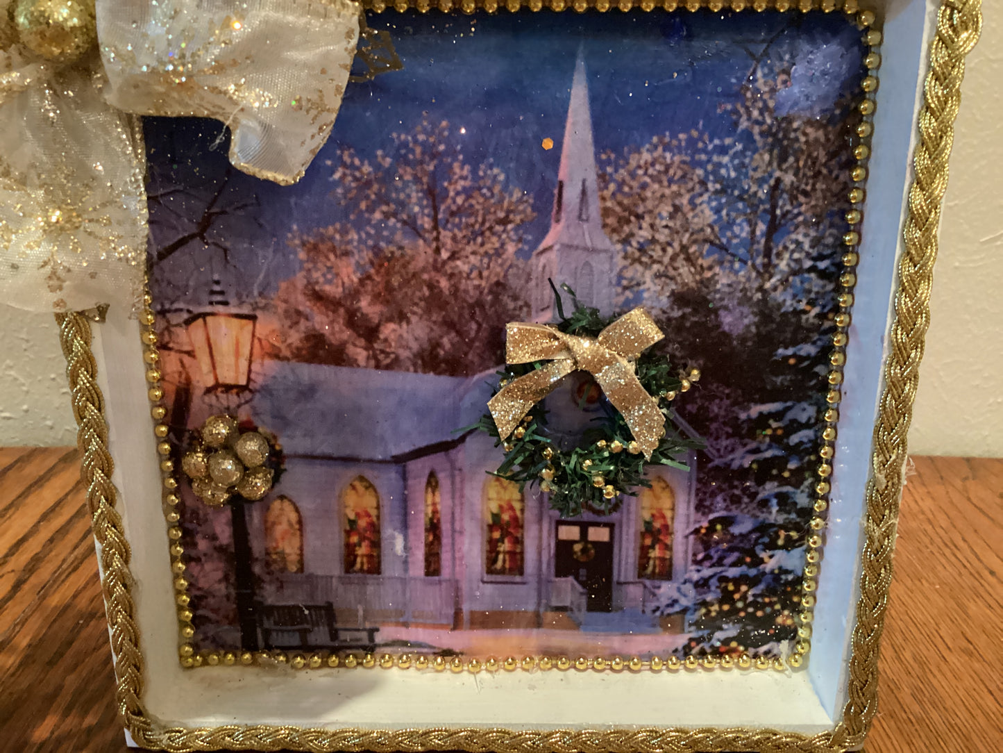 7" X 7" white and gold box with church, Christmas tree, wreath, lamppost, and gold bow