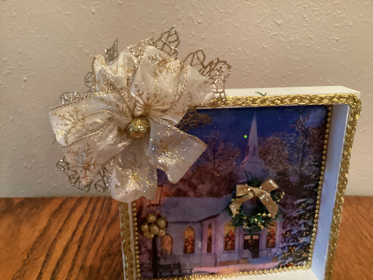 7" X 7" white and gold box with church, Christmas tree, wreath, lamppost, and gold bow